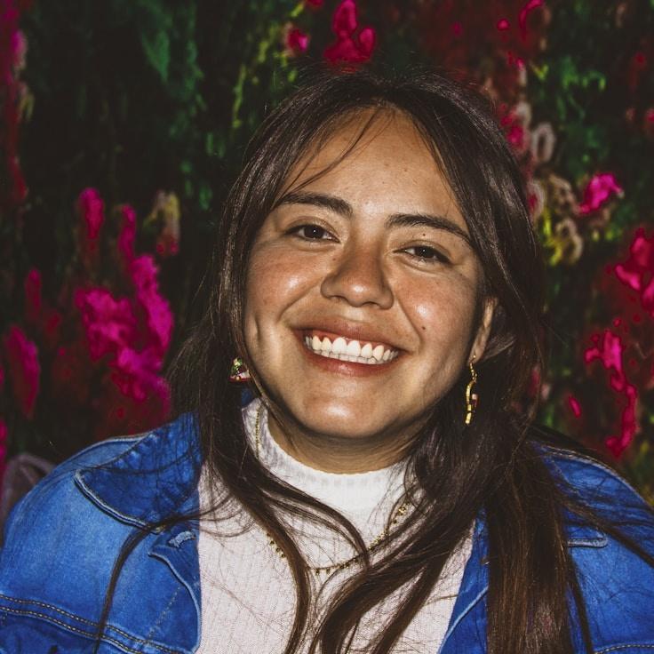 Kaveri Mehta, Lead Design Curator at CloudHarborMead, reviewing corporate floral arrangements